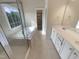 Well-lit bathroom featuring double sinks, a soaking tub, and a glass-enclosed shower for a spa-like experience at 4 Strowd Ct, Durham, NC 27703