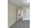Neutral bedroom featuring two solid white doors and gray carpet at 4 Strowd Ct, Durham, NC 27703
