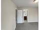 Neutral bedroom featuring an ensuite bath behind a solid white door and gray carpet at 4 Strowd Ct, Durham, NC 27703