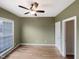 A cozy bedroom featuring hardwood floors, a ceiling fan, and a window for natural light at 4 Strowd Ct, Durham, NC 27703