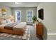 Bright bedroom featuring two windows, a queen-size bed, and a modern dresser with TV for comfortable living at 4 Strowd Ct, Durham, NC 27703