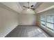 This bedroom features a tray ceiling, ceiling fan, and a window overlooking the side yard at 4 Strowd Ct, Durham, NC 27703