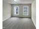 Spacious bedroom with two windows, allowing for natural light and a bright, airy atmosphere at 4 Strowd Ct, Durham, NC 27703