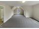 Spacious carpeted bonus room with a unique window design, offering ample natural light at 4 Strowd Ct, Durham, NC 27703