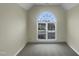Carpeted room featuring a large, arched window, offering plenty of natural light at 4 Strowd Ct, Durham, NC 27703