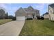 Charming two-story brick home featuring an attached two-car garage and well-manicured lawn at 4 Strowd Ct, Durham, NC 27703