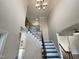 Bright foyer with black and white stairs, wrought iron railing, and a decorative chandelier at 4 Strowd Ct, Durham, NC 27703