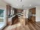 Well-equipped kitchen with stainless steel appliances, a central island, and hardwood floors for a modern feel at 4 Strowd Ct, Durham, NC 27703