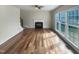 Bright living room with fireplace, hardwood floors, and large windows offering lots of natural light at 4 Strowd Ct, Durham, NC 27703