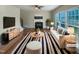Bright living room with a fireplace, hardwood floors, and lots of natural light, virtually staged at 4 Strowd Ct, Durham, NC 27703