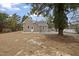 View of the home's exterior and yard, showing gravel and new construction at 408 Charlotte Ave, Sanford, NC 27330