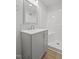 Bright bathroom featuring a modern vanity with gray cabinets and a shower with white tiles at 408 Charlotte Ave, Sanford, NC 27330