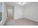 Empty bedroom with neutral carpet, white walls, and a window for natural light at 408 Charlotte Ave, Sanford, NC 27330