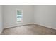 Bright bedroom with a neutral carpet, a window, and fresh paint at 408 Charlotte Ave, Sanford, NC 27330