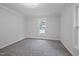 Neutral bedroom with carpet, two windows, and bright lighting at 408 Charlotte Ave, Sanford, NC 27330