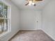 Cozy bedroom with neutral carpet and a window providing ample natural light at 408 Charlotte Ave, Sanford, NC 27330
