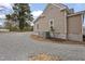 Exterior view of the home featuring gravel driveway and central air conditioning unit at 408 Charlotte Ave, Sanford, NC 27330