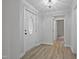 Inviting foyer featuring hardwood floors, a stylish light fixture, and a white front door at 408 Charlotte Ave, Sanford, NC 27330