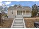 Inviting single-story home with a classic porch, gray stairs, and a well-maintained exterior at 408 Charlotte Ave, Sanford, NC 27330