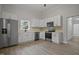 Angle view of kitchen featuring stainless steel appliances and modern white cabinets at 408 Charlotte Ave, Sanford, NC 27330