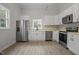Bright kitchen featuring stainless steel appliances, white cabinetry, and a window view at 408 Charlotte Ave, Sanford, NC 27330