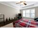 Comfortable bedroom with a cozy bed, media center, and plenty of natural light at 500 Chandler Grant Dr, Cary, NC 27519