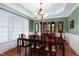 Formal dining room featuring elegant lighting, intricate crown molding, and a classic table set at 500 Chandler Grant Dr, Cary, NC 27519