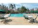 Community pool with lounge chairs and tables, perfect for summer relaxation and socializing at 500 Chandler Grant Dr, Cary, NC 27519