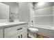 Bathroom features a modern vanity with quartz countertop, single sink, toilet, and tub with shower at 507 W Edwards St, Princeton, NC 27569