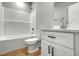 Bathroom featuring tub, toilet and vanity with a white basin, countertop, and modern black hardware at 507 W Edwards St, Princeton, NC 27569
