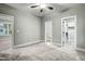 Bright bedroom features neutral paint and carpet, closet, and an adjoining bathroom, enhanced by a ceiling fan at 507 W Edwards St, Princeton, NC 27569