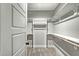 Walk-in closet with multiple shelves and rods for optimal storage, and neutral walls with carpeted flooring at 507 W Edwards St, Princeton, NC 27569