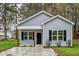 Charming single-story home featuring light gray siding, black shutters, and a welcoming front porch at 507 W Edwards St, Princeton, NC 27569