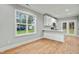 Open floor plan with view to the kitchen with ample lighting, white cabinets, and easy access to the backyard at 507 W Edwards St, Princeton, NC 27569