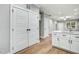 Bright kitchen features modern cabinets, quartz counters, and stainless faucet, complemented by wood-look flooring at 507 W Edwards St, Princeton, NC 27569