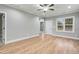 Bright living room with hardwood floors, ceiling fan, and a view to the outside, next to the entrance of a room at 507 W Edwards St, Princeton, NC 27569