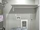 Image of utility room showcasing water heater, shelving and various connectors for washer and dryer at 507 W Edwards St, Princeton, NC 27569