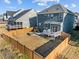 View of fenced backyard with deck, patio, and fire pit at 5121 Windmere Chase Dr, Raleigh, NC 27616