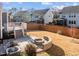 Fenced backyard with a fire pit and patio area with steps to the deck at 5121 Windmere Chase Dr, Raleigh, NC 27616