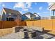 A fire pit and paver patio area are nestled within a fenced backyard at 5121 Windmere Chase Dr, Raleigh, NC 27616
