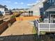 Overhead shot of the backyard with a wooden fence, stone firepit, and raised deck at 5121 Windmere Chase Dr, Raleigh, NC 27616