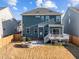 View of the home's backyard featuring a stone fire pit, patio, deck, and fenced yard at 5121 Windmere Chase Dr, Raleigh, NC 27616