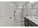 A bathroom with a double vanity, shower, tub and modern fixtures at 5121 Windmere Chase Dr, Raleigh, NC 27616
