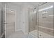 Bright bathroom showcasing glass enclosed shower with tile surround, and a doorway that leads to a bedroom at 5121 Windmere Chase Dr, Raleigh, NC 27616