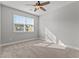 Bedroom featuring neutral paint, plush carpeting, a ceiling fan, and a large window with blinds at 5121 Windmere Chase Dr, Raleigh, NC 27616