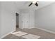 A cozy bedroom featuring carpet, ceiling fan, closet, and neutral paint at 5121 Windmere Chase Dr, Raleigh, NC 27616