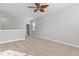 Upstairs Bonus Room featuring neutral paint, plush carpeting, ceiling fan, and a window at 5121 Windmere Chase Dr, Raleigh, NC 27616