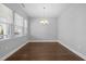 Bright dining room with hardwood floors, a modern chandelier, and large window at 5121 Windmere Chase Dr, Raleigh, NC 27616