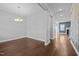 Dining room with hardwood floors, chandelier, and view into adjacent rooms at 5121 Windmere Chase Dr, Raleigh, NC 27616