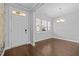 Inviting front foyer with dark wood floors, natural light, and floral wallpaper accent wall at 5121 Windmere Chase Dr, Raleigh, NC 27616
